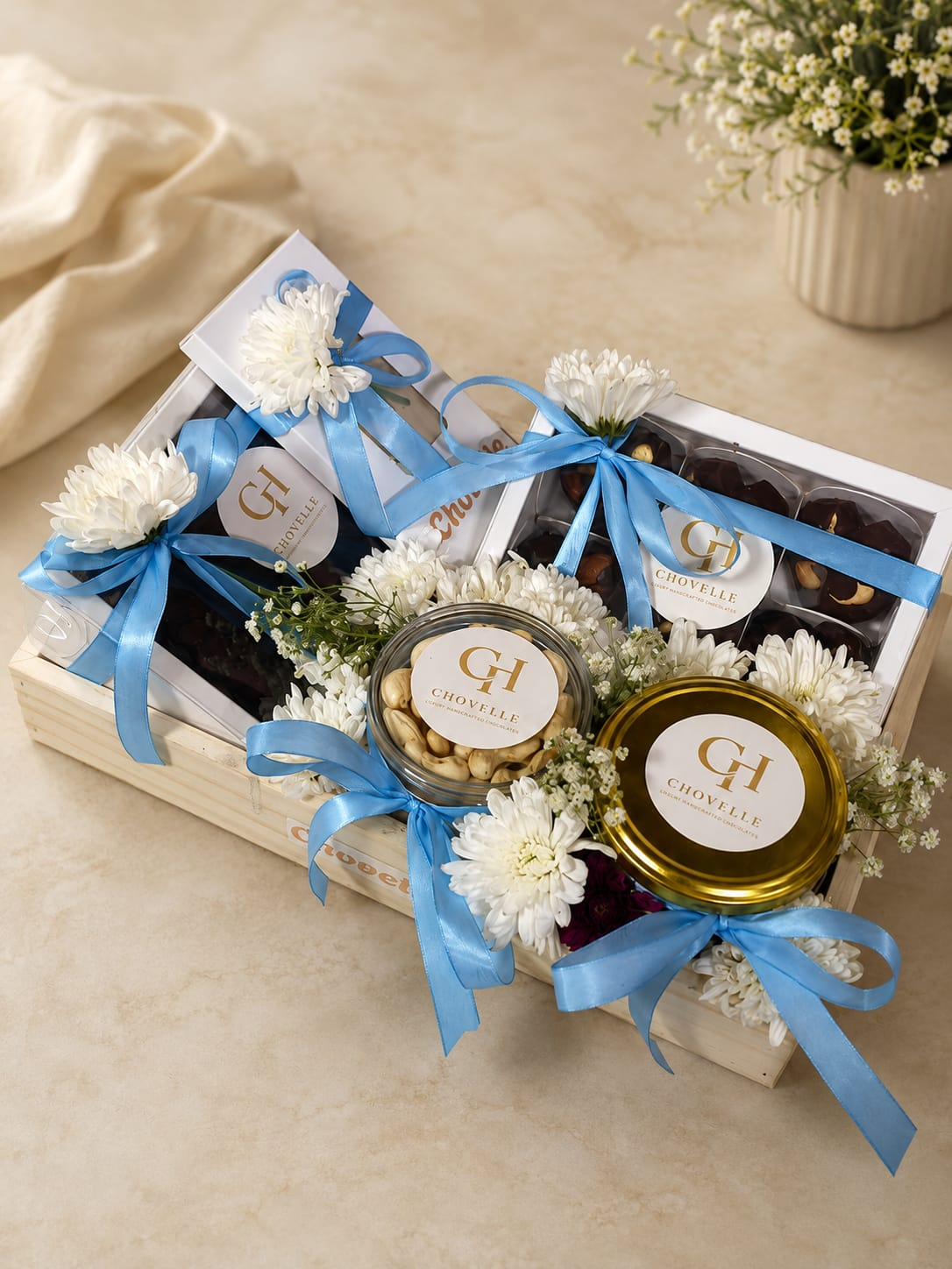 Chovelle luxury gift crate with chocolates, cashews and white flowers for Diwali gifting